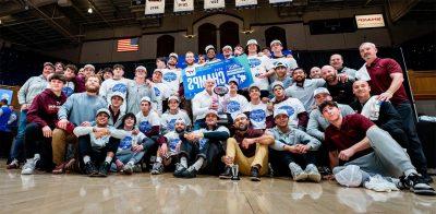 Members of the Virginia Tech wrestling team pose with a trophy for winning the ACC championship.